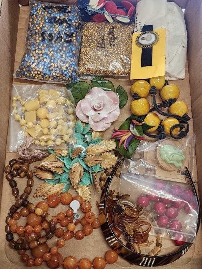 Box full of vintage plastic jewelry, loose rhinestones