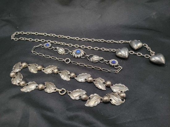 3 Silver tone necklaces, hearts, leaves and floral with blue stones
