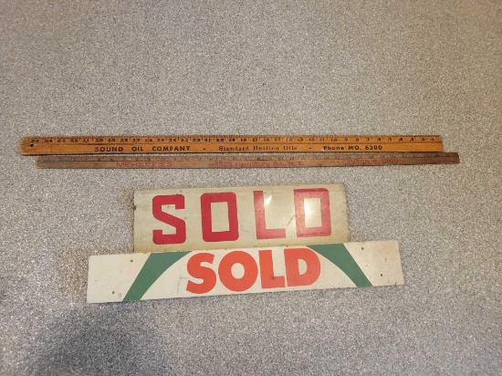 Metal and wood double sided sold signs, advertising yard sticks