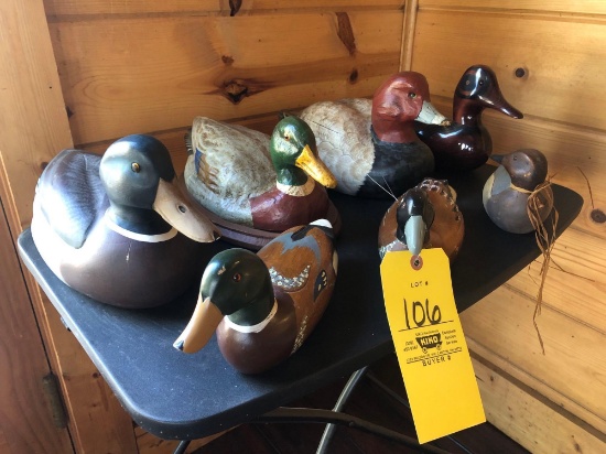 wooden and one plastic duck decoys