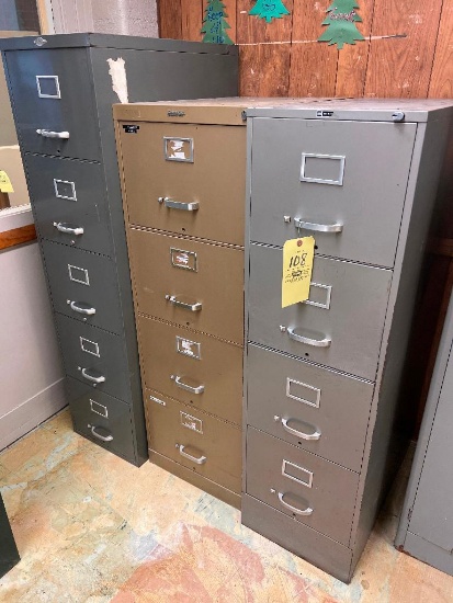 Three metal file cabinets, some drawers are locked
