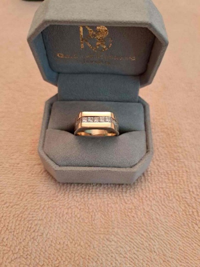 Man's custom-made 14k yellow gold channel-set diamond wedding band. The wedding band contains (11)