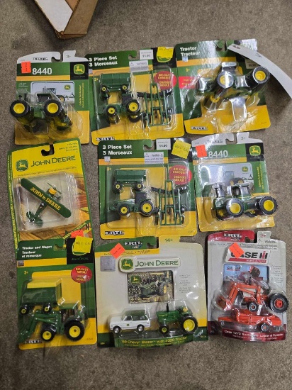 (8] John Deere 1/64, (1) Case Tractor bid x 9