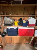 Contents of the shelf - coolers, typewriter, sleeping bags, and blankets