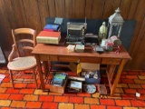 Wooden desk with a chair, radio, CDs, and decor