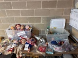 table top of assorted dolls and toy China sets