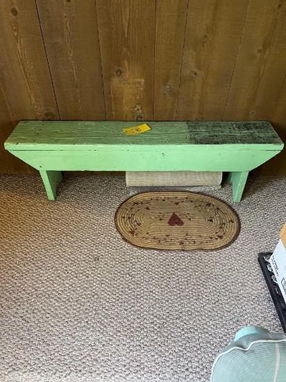 Painted wooden bench and small rug
