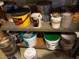 metal shelf and wood shelf with contents, mostly paint
