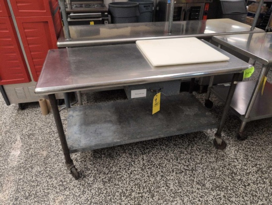 Stainless steel prep table with cutting board, cafeteria