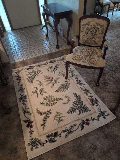 Modern area rug with embroidered arm chair