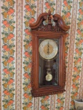 Modern wall hanging battery op clock with decorative wall hangings and plates