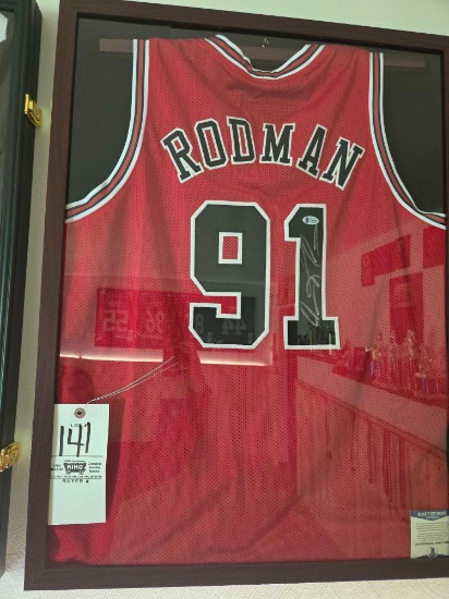 Framed Rodman Jersey with autograph.