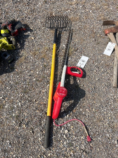 Pitch fork and an electric hedge trimmer
