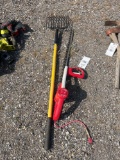 Pitch fork and an electric hedge trimmer