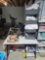 Sewing table, thread, stacked bins with material, iron, and more