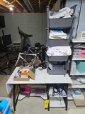 Sewing table, thread, stacked bins with material, iron, and more