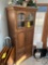 Wooden cabinet with faux plant and contents