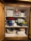 Contents of cabinet - blender, cups, cutting board, fridge organizers