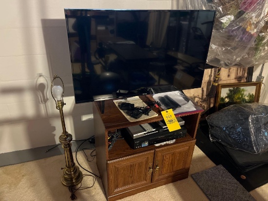 Samsung 42in flatscreen TV with a TV stand vcr players