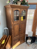 Wooden cabinet with faux plant and contents
