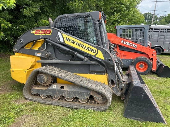 New Holland C238 skid loader with material bucket