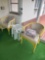 two patio chairs and side tables