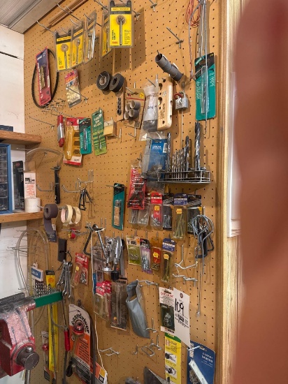 bits, hammers and hardware on pegboard wall