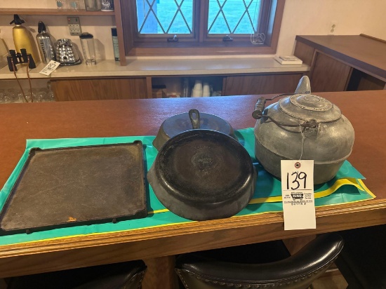 Coffee kettle and cast iron skillets and cast griddle plate.
