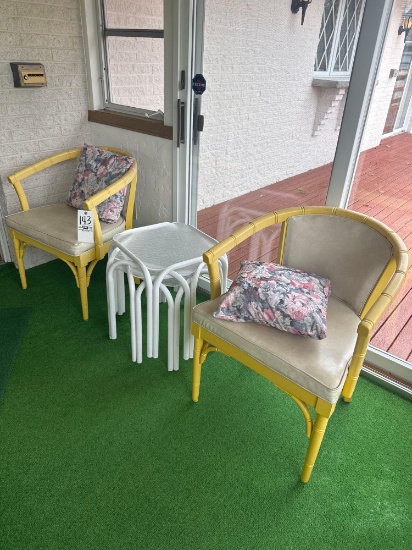 two patio chairs and side tables