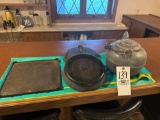 Coffee kettle and cast iron skillets and cast griddle plate.