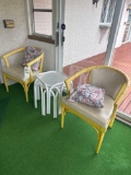 two patio chairs and side tables