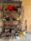 Contents of shelf; hitches, hand tools, weights, caution sign, wd40, jug, car battery, wire, glasses