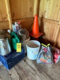 grouping of watering cans, insect killer, traffic cones, milk crate