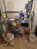 Contents on shelf; vacuum, paint, owl, gloves, paper, Heath Zenith, white viniger