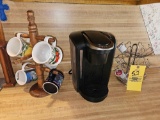 Keurig Coffee Maker, Mug Holder, Capsule Rack, & Mug Assortment