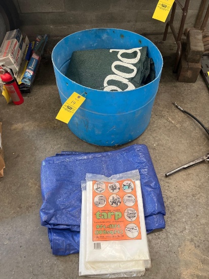 small barrel with assorted tarps