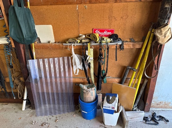 Wall contents - ratchet straps, hangers, shop vac, deer skull