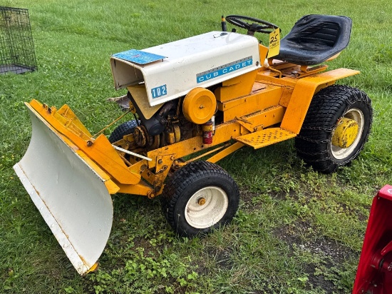 Cub Cadet 102 lawn tractor with blade and mowing deck.