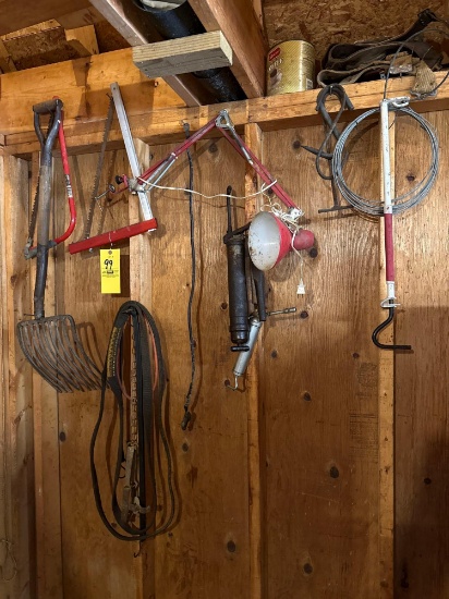 Contents on Wall, hand Saws, Pitch Fork, grease Guns, light, Straps