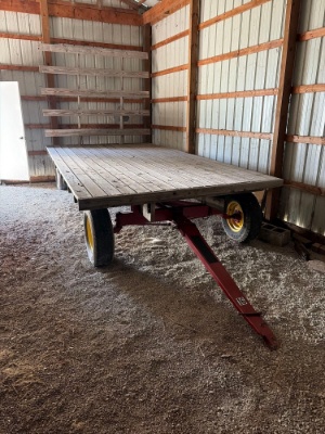 16ft flatbed hay wagon with back rack on New Holland running gear
