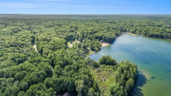 Build on this Half-Acre Lot in Lakes of the North, Michigan!