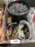 bucket of nails and plumbing fittings