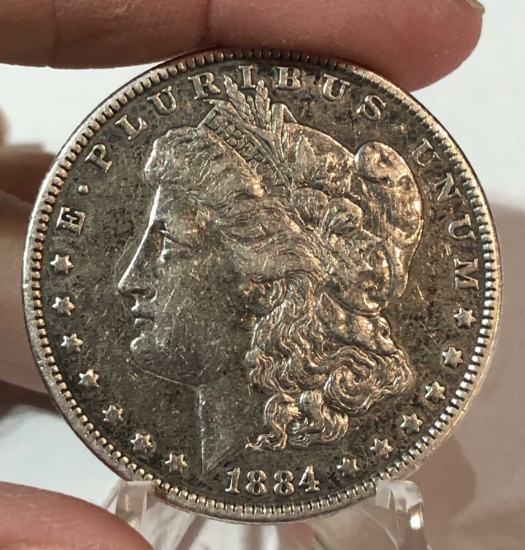 1884 Morgan Silver $1 Dollar Coin Has some Glue loking Substance on Back.  See picture