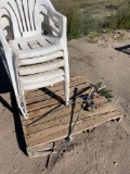 Four lawn chairs, two fishing poles
