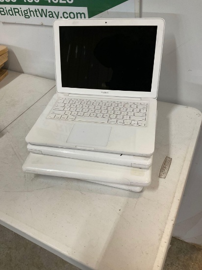 Four Apple laptop computers