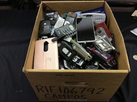 Box of cell phones and phone parts