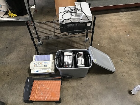 cart with two printers and paper cutter with box of office phones