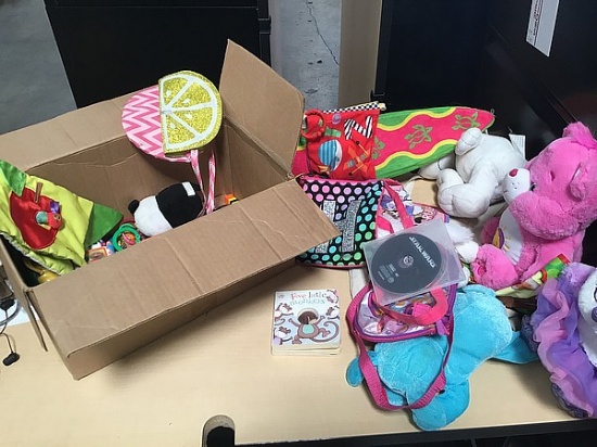 Box of kid stuffed animals and toys