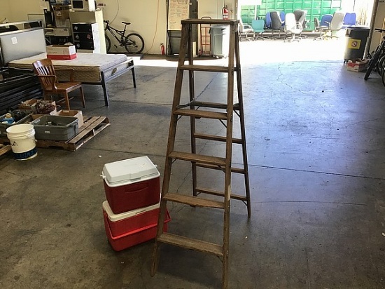 Wooden ladder with two red coolers