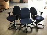 Three blue office chairs